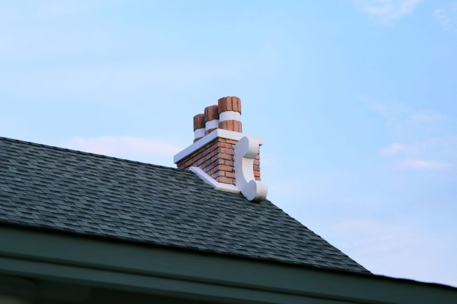 chimney-on-house-roof-closeup-blue-sky-background-2024-12-07-12-44-12-utc