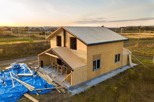 Construction of new and modern modular house. Walls made from composite wooden sip panels with styrofoam insulation inside. Building new frame of energy efficient home concept.
